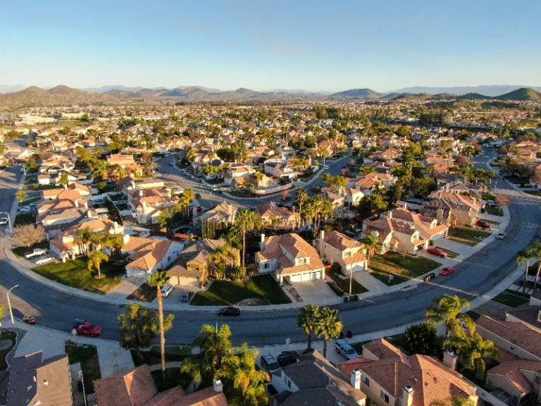Suburban neighborhood with houses, curved streets, and distant mountains under a clear sky. water damage restoration in Bell Canyon CA