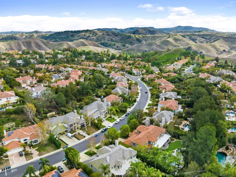 Suburban neighborhood with houses, trees, and winding roads near rolling hills. Professional water damage restoration in Woodland Hills CA. Fast, reliable services to repair, clean, and restore homes and businesses efficiently.